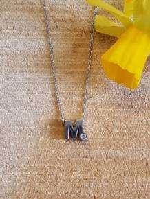 initials letter M met Zirkonia Joy de la Luz